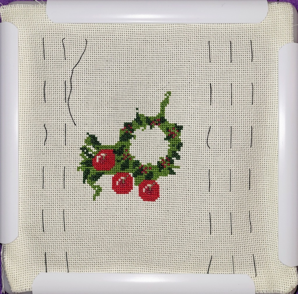 Progress on Christmas Wreath cross stitich, center ring on of greens done, and 3 apples